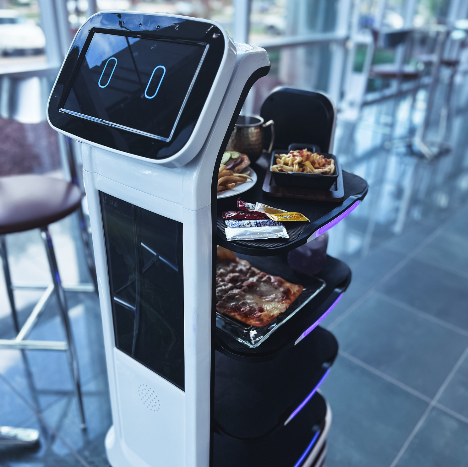 waiter robot bringing food to restaurant guests