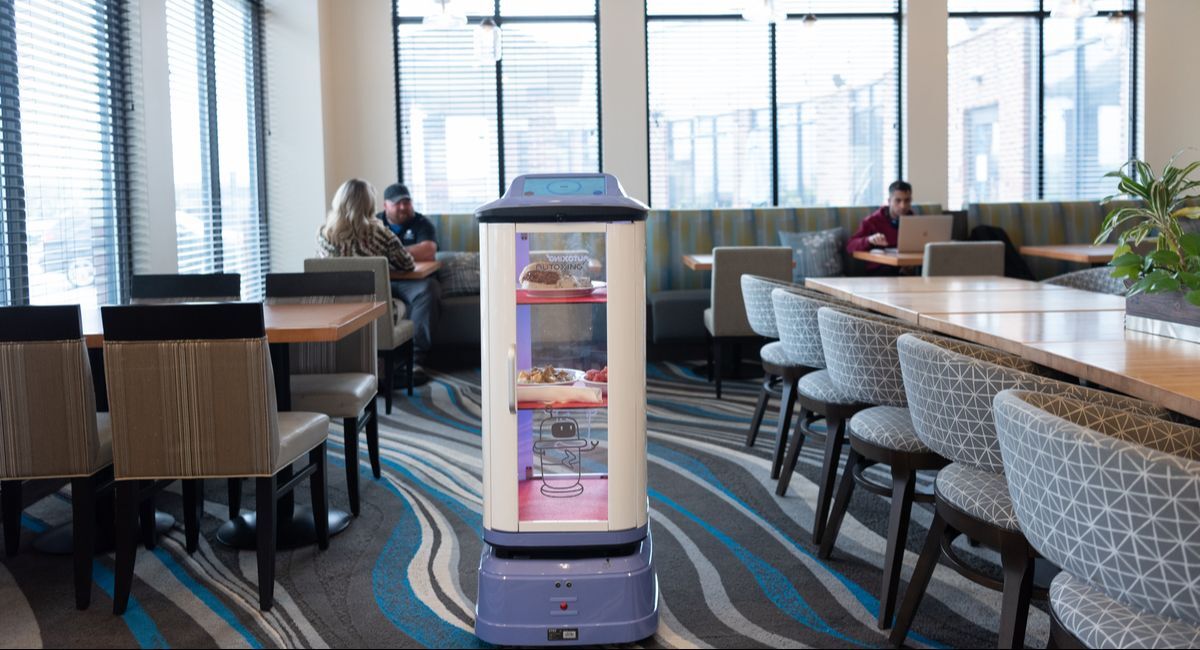 Restaurant Guests Getting Food Delivered by Waiter Robot