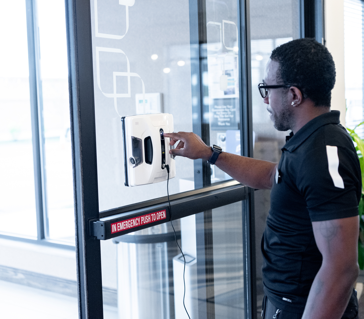 Man operating a window cleaning robot
