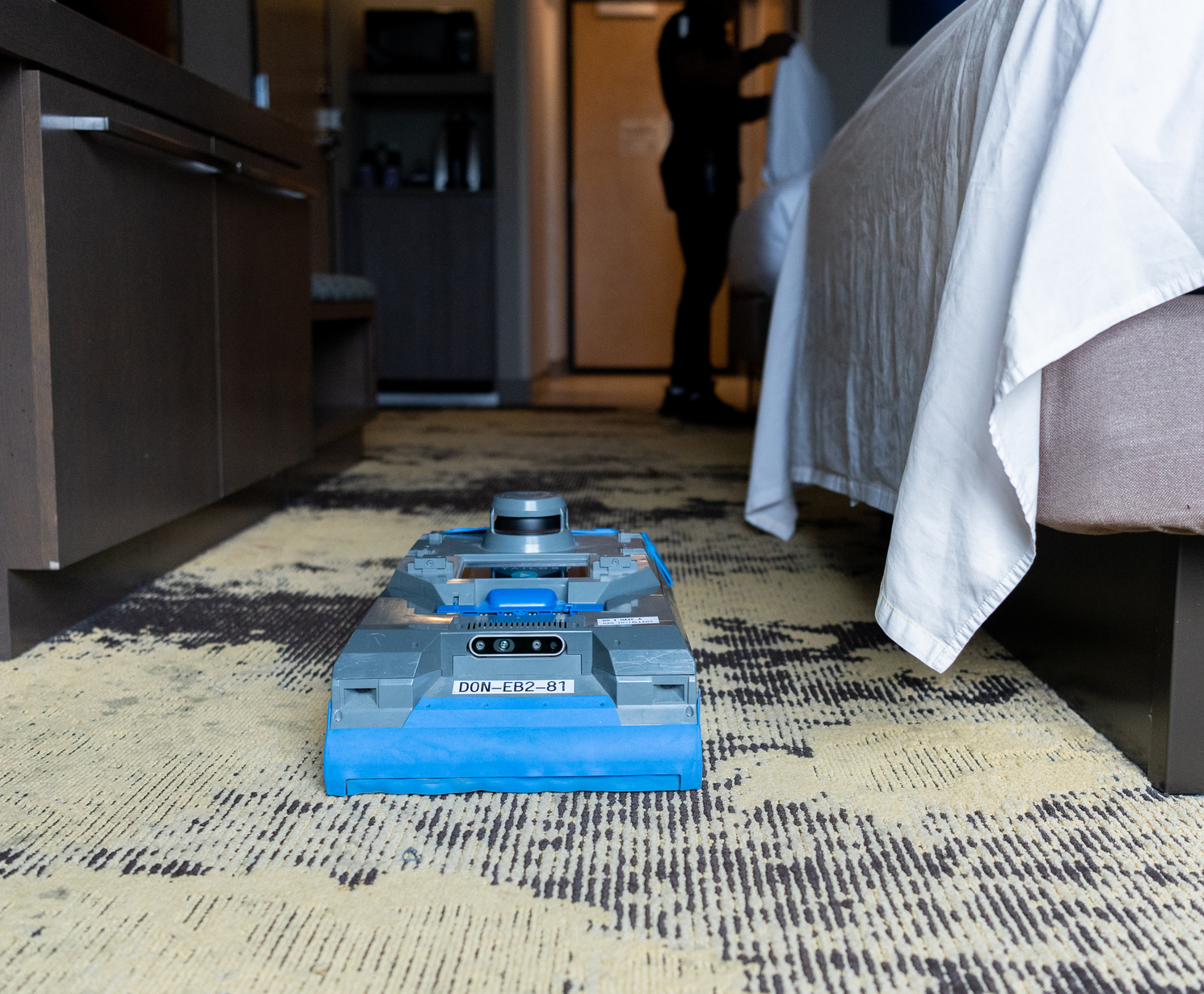 Cleaning Robot vacuuming the floor of a hotel room